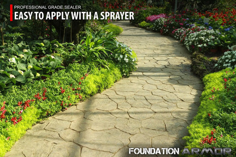 Top Shelf Solvent Based Silane Siloxane Concrete Sealer For Brick Pavers And Natural Stone With Sleek Matte Water Repelling Finish 5 Gallon Drum on a stone path surrounded by colorful flowers.