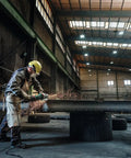 Worker using 7 Inch Angle Grinder With 8500 RPM And 15 Amp Power, Paddle Switch, VibraTech Damping, for heavy-duty grinding