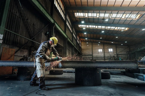 Worker using 7 Inch Angle Grinder With 8500 RPM And 15 Amp Power, Paddle Switch, VibraTech Damping, for heavy-duty grinding