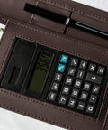 Career Game Changer Business Padfolio With Heavy Duty Zipper Closure Crafted From Smooth Pu Vegan Leather Featuring A Roomy 101 Inch Tablet Sleeve Built In Solar Calculator And Clever Desk Organizer For Bosses In Rich Brown showing solar calculator detail.
