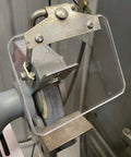 Dead Nuts Drop In Replacement Eyeshield For Bench Grinders featuring clear Lexan lens mounted on grinding machine.