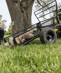 Heavy Duty ATV Trailer With 27.5 Cu Ft Bed, 1,400 Lb Load Capacity, Black Steel Utility Dump Cart with rocks on grass