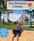 Outdoor Baby Swing Sun Shade For Toddlers, Portable Folding Canopy That Blocks UV Rays in use on a sunny day with child swinging.