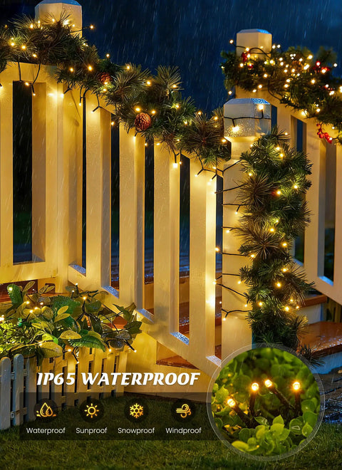 Two Pack 80 Foot 200 LED Solar String Lights Outdoor Waterproof glowing on a railing in rain showing IP65 waterproof feature
