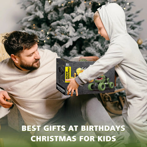 Child in pajamas receiving Awesome All Terrain Dinosaur RC Car For Kids With 2.4Ghz Remote Control Light Up 4WD Off Road Monster Truck box