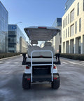Rock Solid 6 Seater Electric Golf Cart With 48V Lithium Battery And 14 Inch Off Road Tires White all terrain leisure vehicle rear view on urban street.