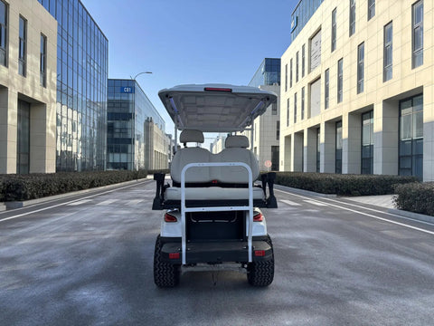 Rock Solid 6 Seater Electric Golf Cart With 48V Lithium Battery And 14 Inch Off Road Tires White all terrain leisure vehicle rear view on urban street.