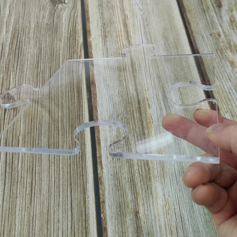 Four In One Acrylic Router Template Kit For Charcuterie Boards And Woodworking, clear puzzle piece template in hand.