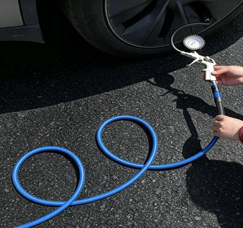 Person using Heavy Duty 1/4 Inch By 100 Ft Air Compressor Hose Rated 300 Psi to inflate a car tire on asphalt.