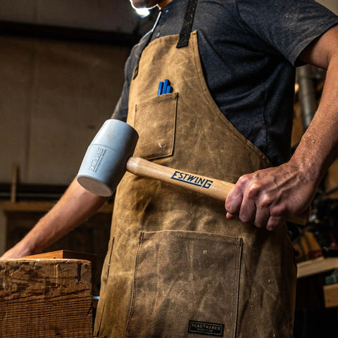 Deadhead Rubber Mallet With Bounce Resistant Head And Hickory Wood Handle 12 Oz No Mar Hammer held by person in workshop