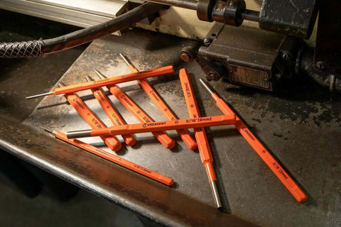 Extended Length Punch and Chisel Set for Metalworking and Carpentry, Pro Grade 12 Piece with Striking Cap on workshop table
