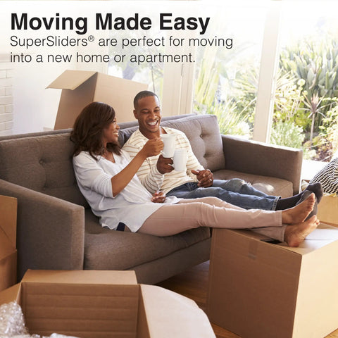 Couple sitting on sofa surrounded by moving boxes, using 20 Piece Assorted Felt Furniture Sliders Set For Hard Surfaces.