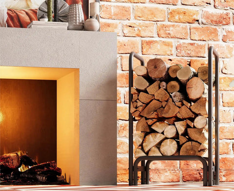 Sturdy Firewood Rack And Log Holder For Indoor Outdoor Use Heavy Duty 25mm Tubular Steel Log Storage Stack Supports Up To 400 Pounds Rustproof Black Powder Coated Firewood Organizer For Fireplace And Patio next to a brick wall