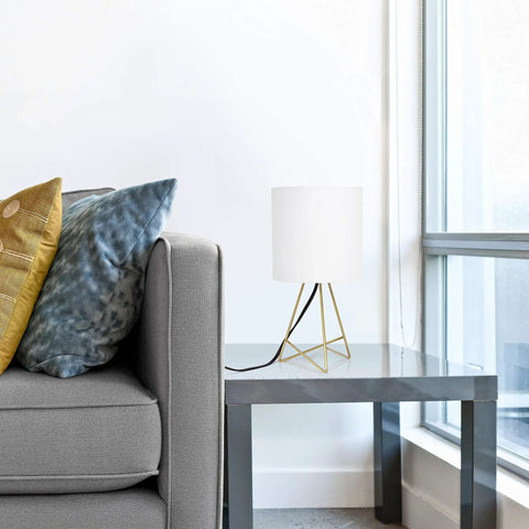 13.5 Inch Down To The Wire Metal Table Lamp With Gold Base And White Fabric Shade, Cord Switch, on side table by sofa.