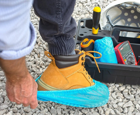 Person putting on Ultra Thick Disposable Shoe Covers 120 Pack 60 Pairs Non Slip Water Resistant Booties for Outdoor Use