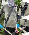 Universal Trimmer Shoulder Strap Harness For Weed Whackers And Leaf Blowers shown worn, nylon material, secure clamp attachment.