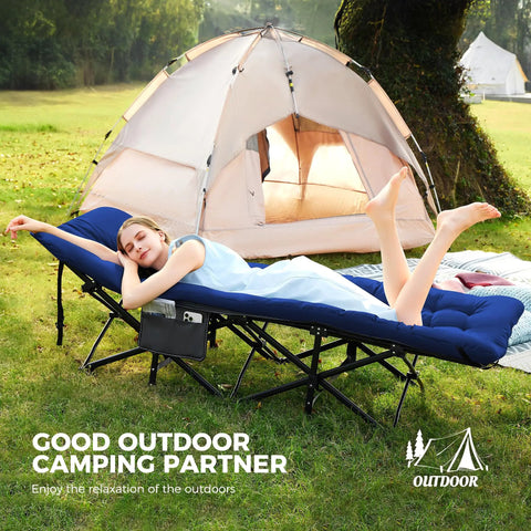 Woman relaxing on Extra Wide Camping Cot for Adults With Mattress, Heavy Duty 1200D Oxford Fabric Folding Cot next to a tent.