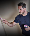 Man applying Spackling For Interior And Exterior Use 1/2 Pint White No Mess Easy To Use Squeeze Tube With Dry Time Indicator on wall