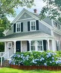 Wooden Garden Edging Border With Burnt Wood Finish Flexible No Dig Landscape Border in front of house with hydrangeas