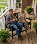 Tough As Nails Two Seater Outdoor Bench With Cup Holder Crafted From Premium Fade Resistant Hdpe For Patios Yards And Decks Handles Up To 660 Pounds Easy Clean All Weather Hangout Spot In Black with two people enjoying drinks on a porch.
