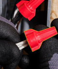 WingTwist WT52 Red Wire Connector 25 Pack with contoured wing design shown in use connecting copper wires for secure grip.