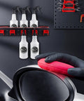 Multifunctional Spray Bottle Rack For Car Garage And Beauty Shop Displays With Durable Metal Frame And Five Plastic Hanging Hooks Holds Plastic And Squeeze Bottles Perfect For Organizing Spray Bottles In Vehicles Homes Or Shops Size 21.7 By 4.7 By 4.7 mounted on wall with spray bottles hanging, hand polishing car.