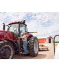 Farmer refueling tractor with Goldenrod Water Absorbing Fuel Filter Replacement Canister With 10 Micron Filtration