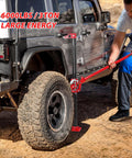 Person using High Lift Recovery Jack 33 Inch 3.5 Ton Heavy Duty Off Road Farm Lifting Equipment on SUV tire in off-road setting.