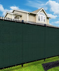 Heavy Duty HDPE Privacy Fence Screen With Custom Sizes For Outdoor Shade Coverage On Patios, Gardens, Yards And Balconies In Dark Green Durable Weather Resistant UV Blocking Material, installed in a yard