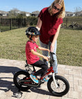 Child riding a bike with Training Wheels For 12-18 Inch Kid Friendly Bikes With Heavy Duty Steel Brackets And Quiet Rubber Tires.