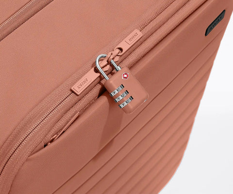 Close-up of Softside Bigger Carry On Luggage 23 Inch Expandable with TSA color matching padlock in cloud gray.