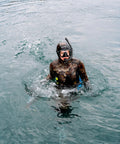 Diver in full wetsuit using Neo Slix Wetsuit Entry Lubricant 16.9 Fl Oz Water Based Silicone Free Formula in open water for easy wetsuit entry.