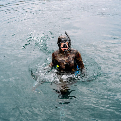 Diver in full wetsuit using Neo Slix Wetsuit Entry Lubricant 16.9 Fl Oz Water Based Silicone Free Formula in open water for easy wetsuit entry.