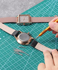 Heavy Duty Watch Band Pins And Spring Bar Tool Kit With 76 Stainless Steel Pins For Quick Band Removal And Repair All In One Handy Watch Strap Repair Set For Men And Women in use on a leather watch strap