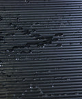 Tough As Nails Vinyl V Groove Floor Mats For Garages Shops And Commercial Spots Oil Grease Chemical Resistant non-slip mat with water droplets in black.