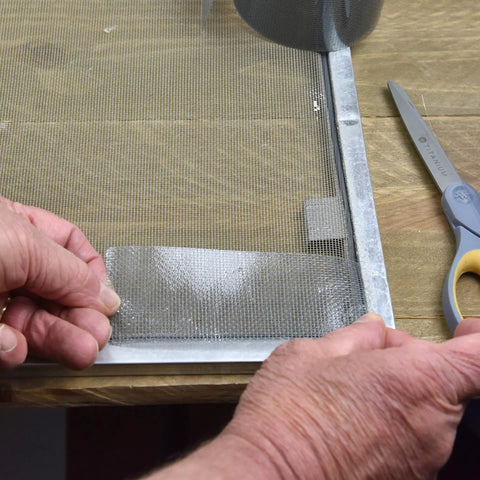 Applying Screen Repair Patch Kit With Fiberglass Mesh And Strong Adhesive For Window And Door Screens to fix a tear