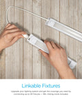 Hands connecting Premium Linkable LED Under Cabinet Light 12 Inch 415 Lumens 3000K Warm White using linking cord on wooden surface