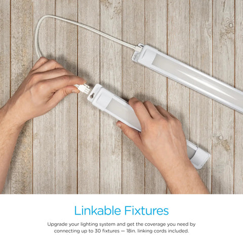 Hands connecting Premium Linkable LED Under Cabinet Light 12 Inch 415 Lumens 3000K Warm White using linking cord on wooden surface