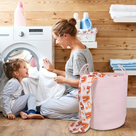 Mother and child doing laundry with Large Tall Cotton Rope Laundry Basket Hamper With Handles For Nursery And Living Room, Boho Style, Light Pink.