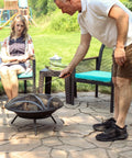 Man using 16 Inch Fire Pit Poker With Heat Resistant Resin Handle, Built Tough Campfire Tool For Indoor And Outdoor Use.