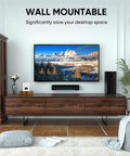 Living room setup with wall-mounted TV and 2.1 Channel Sound Bar With Subwoofer For TV And PC Gaming Kickin Bass For Movie Night Deep Bass Home Theater System With Bluetooth AUX Optical Wall Mountable 17 Inch Immersive Surround Sound