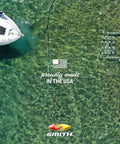 Overhead view of a boat docked on clear water with text 'Proudly Made in the USA' visible next to the boat's hull.