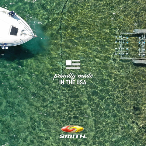 Overhead view of a boat docked on clear water with text 'Proudly Made in the USA' visible next to the boat's hull.