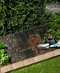 Heavy-Duty Weed Barrier Fabric 4 By 100 Feet Breathable Woven Polypropylene Ground Cover installed in a garden bed.
