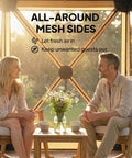 Two people sitting inside a No Tool Setup 10 X 11 Ft Pop Up Gazebo Screen Tent with mesh netting and wooden frames, outdoors.