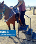 Heavy Duty Three Step RV Stair With Solid Handrail Steel Frame Rated For 600 LBS Load Capacity Tough Universal Rust Proof Kickstep Platform For Overlanding Rigs Trucks And Pop Up Campers being used to mount a horse.