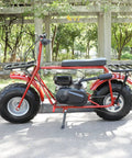 Red mini bike with installed Exhaust Muffler Silencer for Predator 196cc to 420cc engines and GX clones in a park setting