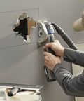 Person using Rock Solid Heavy Lifter 20V Compact Circular Saw Kit for plunge cuts in drywall with a hole cut out.
