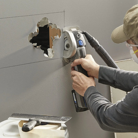 Person using Rock Solid Heavy Lifter 20V Compact Circular Saw Kit for plunge cuts in drywall with a hole cut out.