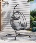 Cozy Outdoor Hanging Egg Chair With Stand For Patio And Garden, wicker design, grey cushions, on patio, side view